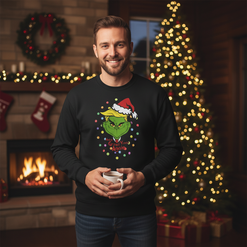 Man wearing a black sweater with a festive design, holding a mug in a cozy room with a Christmas tree and fireplace.